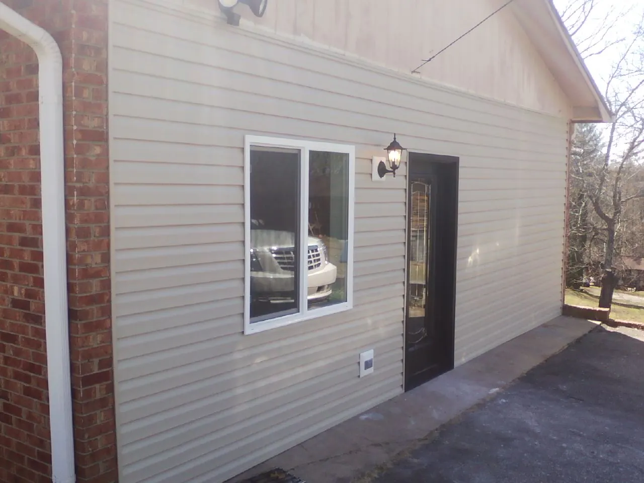 New vinyl siding and entry door on a room addition in Portage